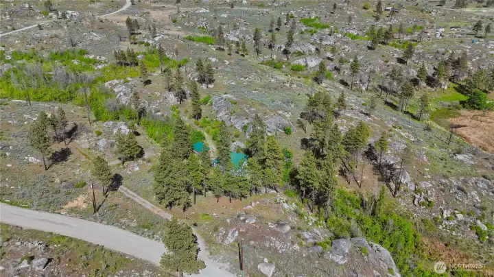 20 scenic acres featuring natural rock outcroppings, trees, with seasonal creek frontage and wildlife throughout