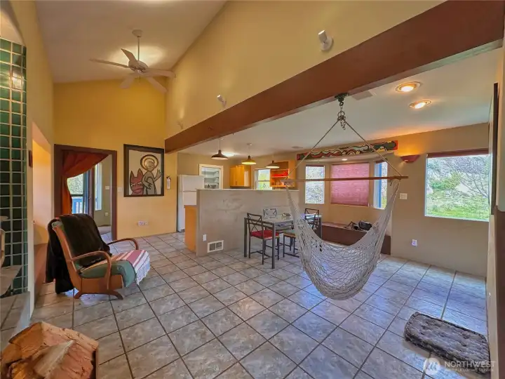 The wood stove and large windows that provide natural light offer a warm and inviting setting