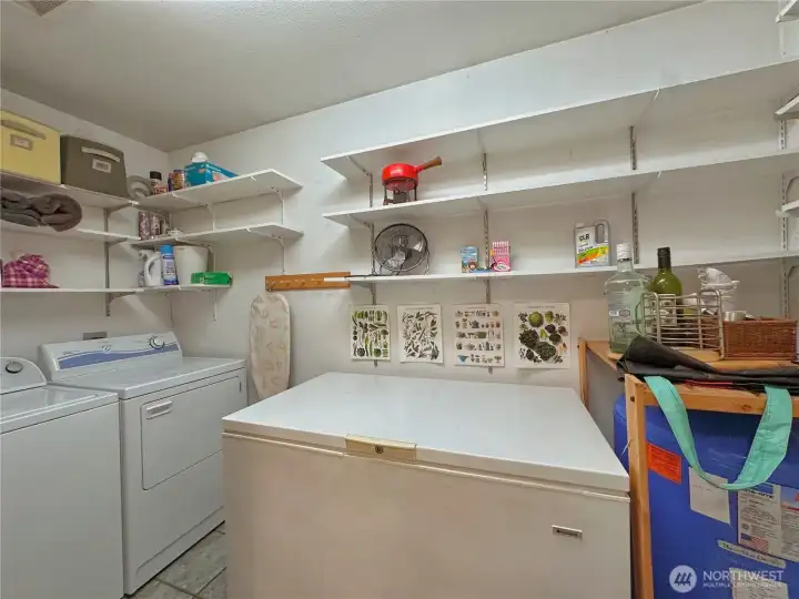 Spacious utility room with ample shelving, providing convenient pantry and storage space