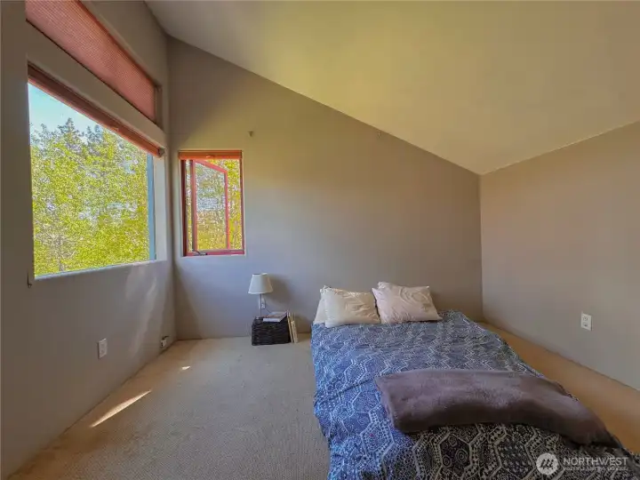 Guest bedroom with vaulted ceiling enhance the sense of space and openness