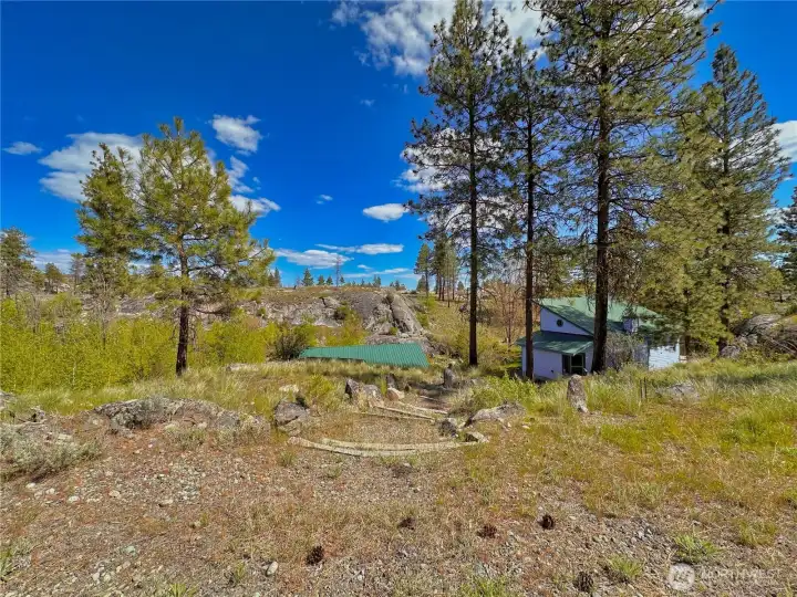 This private tucked away home on a vast 20 acres is conveniently located off a well-maintained road for all season access