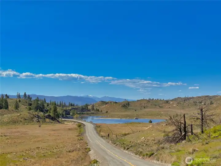 Cameron Lake is 2 miles down the road. Not a bad view if you have to travel to work daily! Downtown Okanogan for shopping/dining is just 10 minutes away and Omak amenities are under 15 miles.