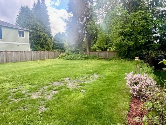 The level lot is fully fenced & has 3 wonderful mature trees along the back property line.