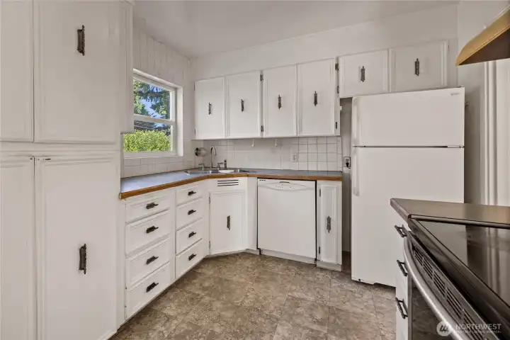 The kitchen space offers a nice view of the fully fenced yard and features an adjacent dining room and larger-sized living room. The kitchen space offers a nice view of the fully fenced yard and features an adjacent dining room and larger-sized living room.