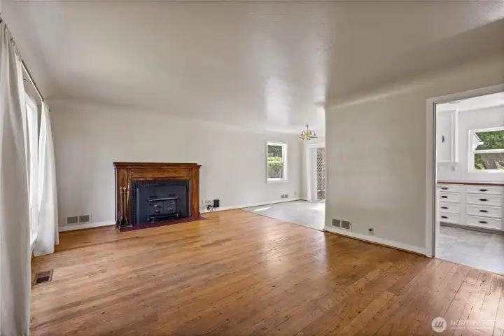 The spacious living room features coved ceilings, hardwood floors, amazing natural light through the large windows, and a gracious space. The spacious living room features coved ceilings, hardwood floors, amazing natural light through the large windows, and a gracious space.
