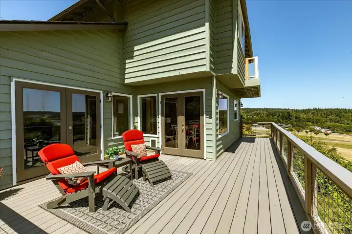 View on the deck showing the 2 sets of french doors, one to the kitchen and the other to the family room with fireplace View on the deck showing the 2 sets of french doors, one to the kitchen and the other to the family room with fireplace