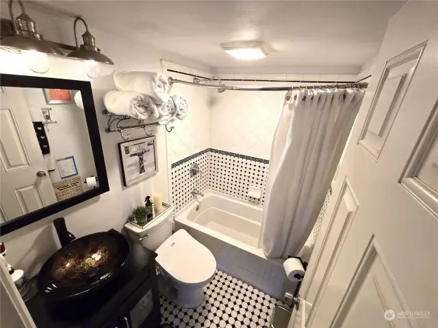 Bathroom has an oversized tub/shower and heated tile floors.