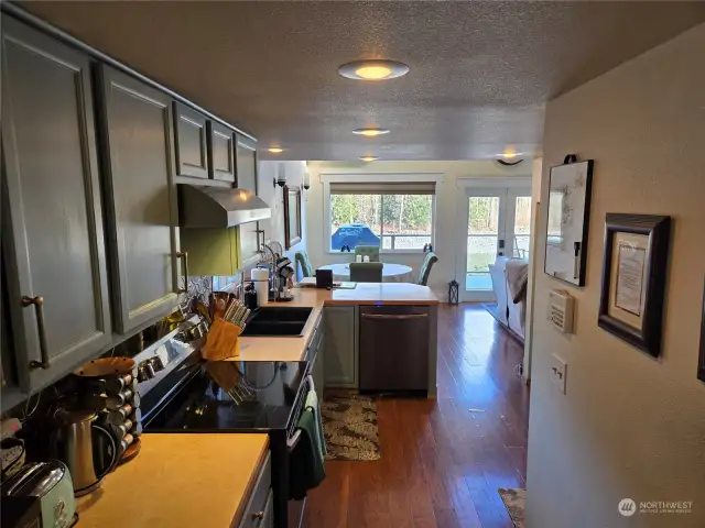 The entry hallway leads to a warm, inviting kitchen.