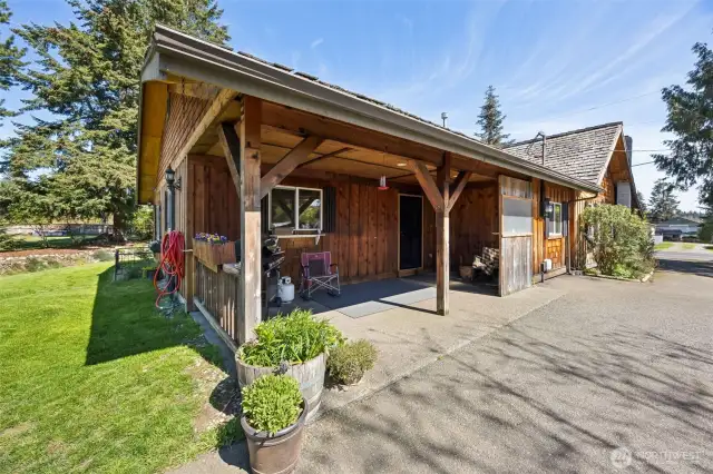 Custom country home with covered front porch sitting area.