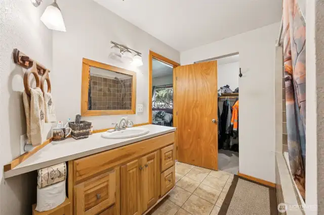 Primary bathroom with tub/shower combo & large walk-in closet.