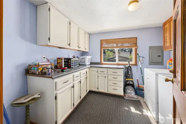 Main floor utility room with lots of cabinets & bright window to allow lots of light.