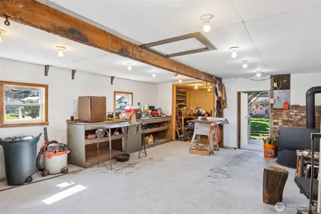 Inside of shop space has a wood burning stove- 531 sq ft. Could possibly be an additional covered parking area.