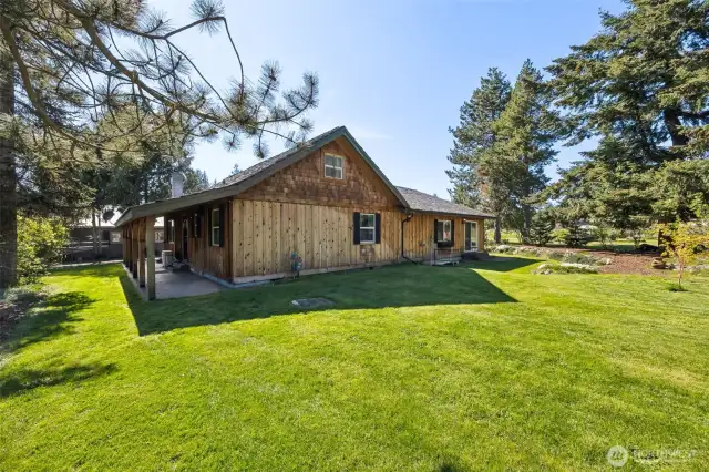 This side of the yard offers lots of flat yard to play- the circular drive is on the right of this photo & wraps around the rear of the house.