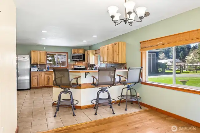 Between the dining area & kitchen is a breakfast bar easily seats 3 large barstools looking out a large picture window of the front yard.