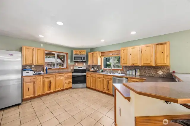 Large open kitchen with plenty of countertop & cabinet space. Two windows in the kitchen & one in the dining area allow light to flood these areas.
