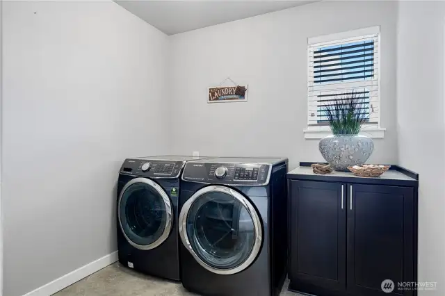 Laundry room with shelfs and ample space for ironing board
