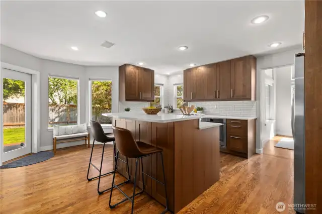 Tasteful updates in the kitchen include new cabinetry, quart counters and subway tile backsplash.
