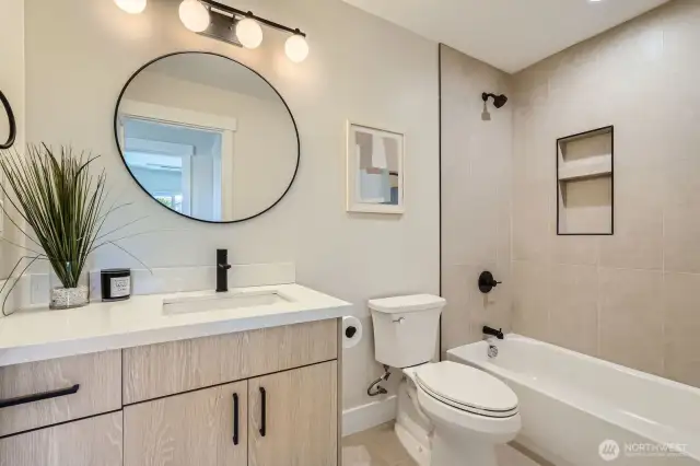 Full bath with tub/shower combo.