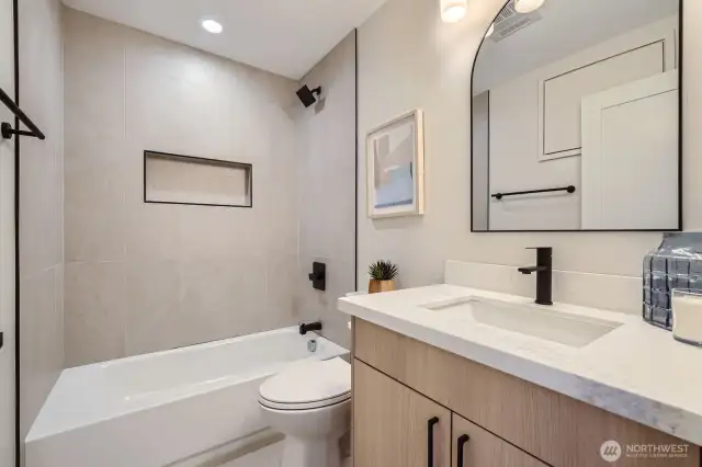 Full bath with tub/shower combo.