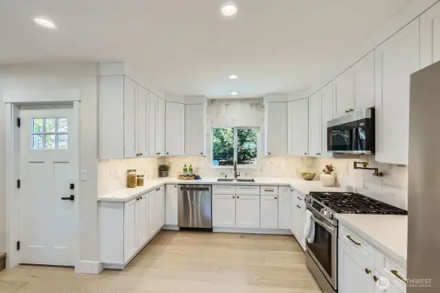 Stunning kitchen with white cabinetry and stainless appliances.