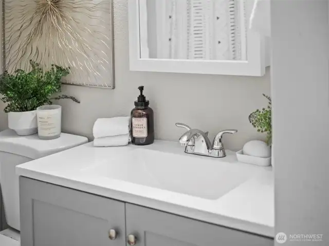 The bathroom features a new vanity and full size tub and shower.