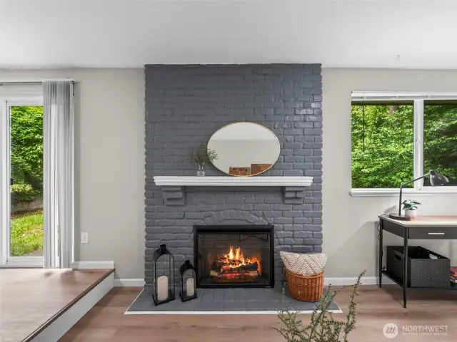 The grey brick fireplace gives a nod to modern color schemes. The electric fireplace produces heat as well as changes color for ambiance.