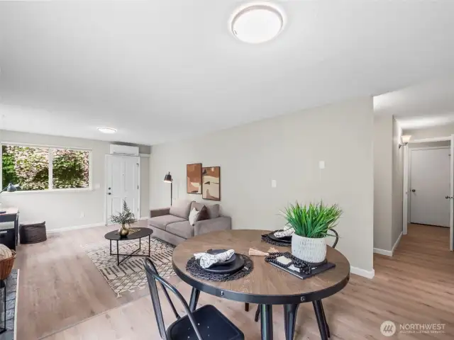 The dining space connects to the kitchen and hallway leading to the bedrooms as well as the bathroom and shared laundry room.