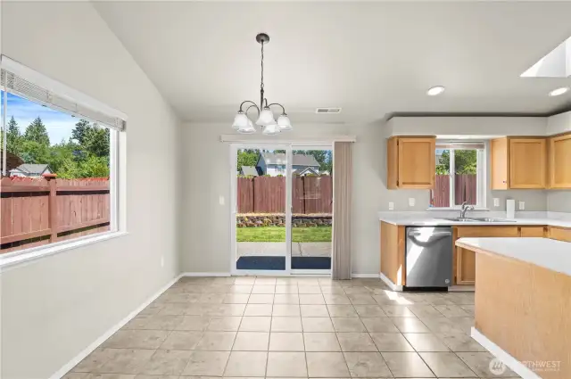 Eating space, kitchen and backyard view.