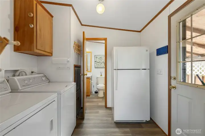 Utility room with extra refrigerator and back door