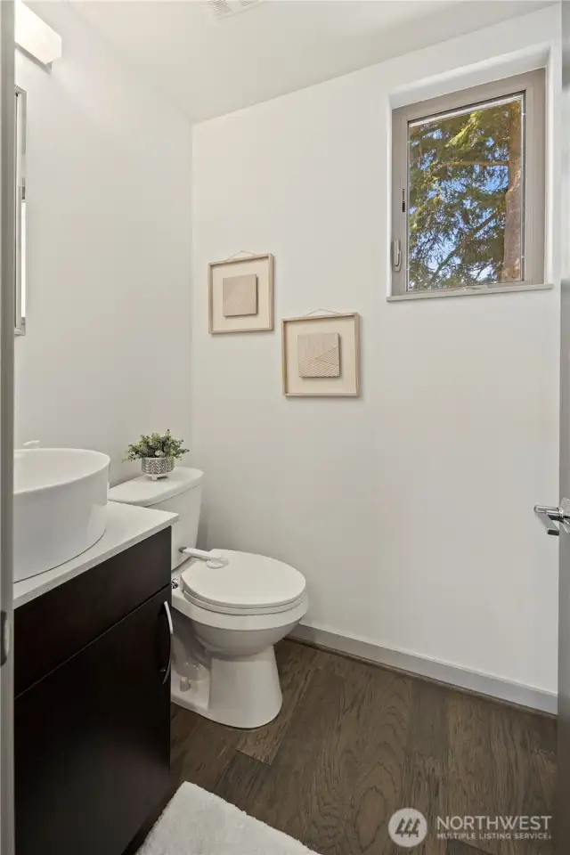 Half bath on level with kitchen, dining and living rooms