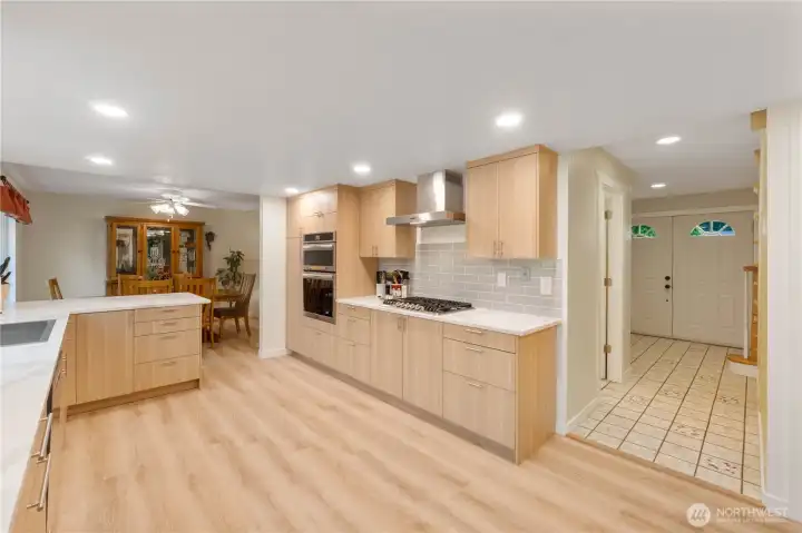 This heart of the showcases sleek quartz countertops, a gas range,  a regular oven, and an upgraded oven/microwave combo, great for cooking for your upcoming Holiday gathering!