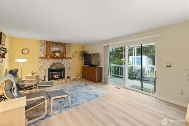 The spacious family room off of the kitchen offers the perfect place to gather and relax, featuring a cozy gas fireplace. The sliding glass door brings in the natural light from outdoors and provides easy access to the deck.