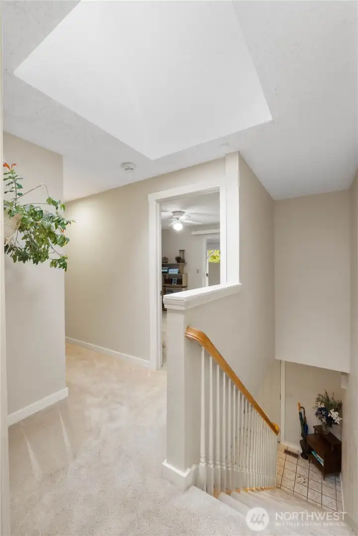 The stairwell is light & bright enhanced by a large skylight that opens and closes to bring in fresh air and natural light.  The stairs were previously upgraded, opened up to allow for more light and the railings were redone to add a stylish and modern touch.