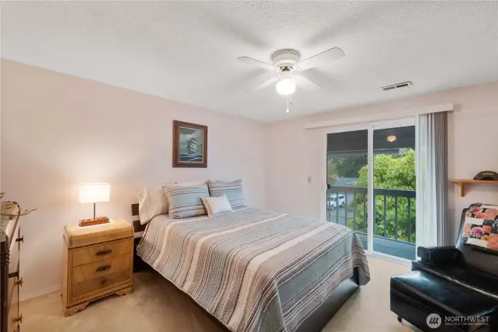 This 3rd bedroom is filled with natural light from the slider doors that lead to the front porch. The addition of the front porch extends the living space to the outdoors!  Ideal for enjoying morning coffee, reading your favorite book, or simply taking in the fresh air.