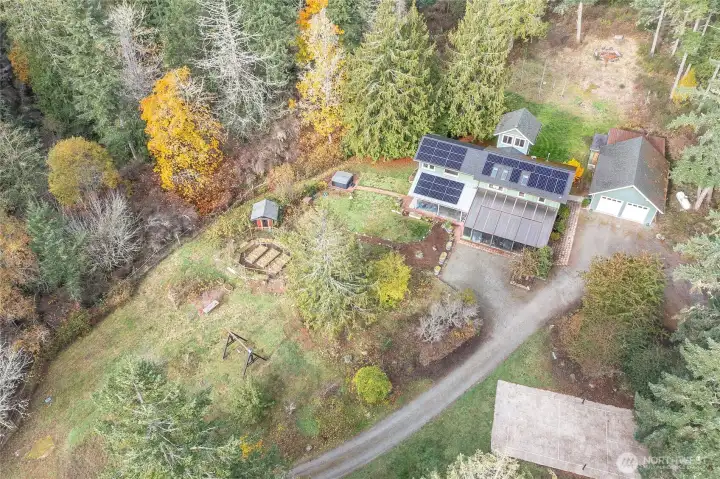 Enjoy a sunny, park-like setting with mature gardens, a welcoming fire pit, relaxing hot tub, and athletic court ideal for outdoor fun and year-round enjoyment.