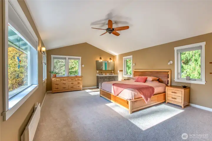 Spacious primary bedroom with a convenient sink vanity.