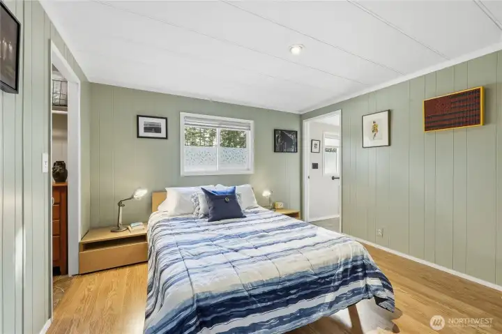 Primary bedroom with walk-in closet on the left, and ensuite with shower on the right.