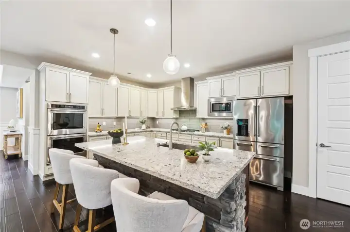 Double ovens, gas cooktop with hood, s/s refrigerator, oversized island