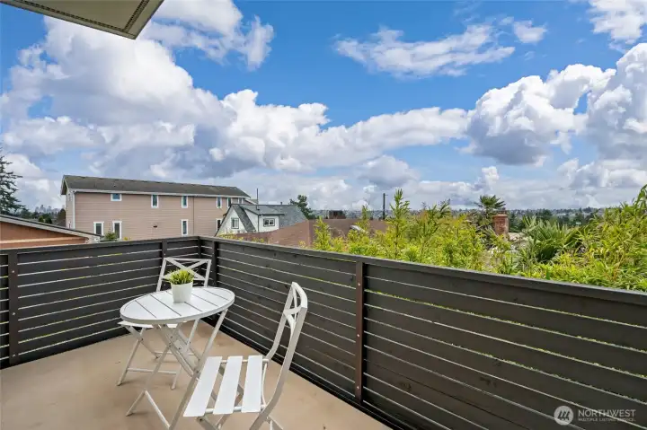 Deck off the main living space with protected views of the Olympics and a peek view of the city.