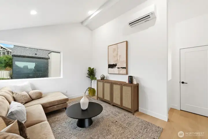 Third floor bonus room with vaulted ceilings, large windows, and access to the covered rooftop deck.