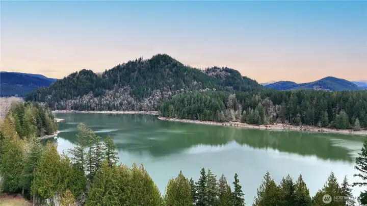 A sweeping aerial view of stunning Alder Lake with it's distinctive turquoise water surrounded by the Tatoosh Range.