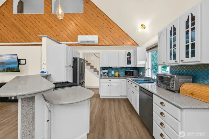 This updated kitchen features stainless appliances, a gas range, and vaulted ceilings that keep the space bright and open.