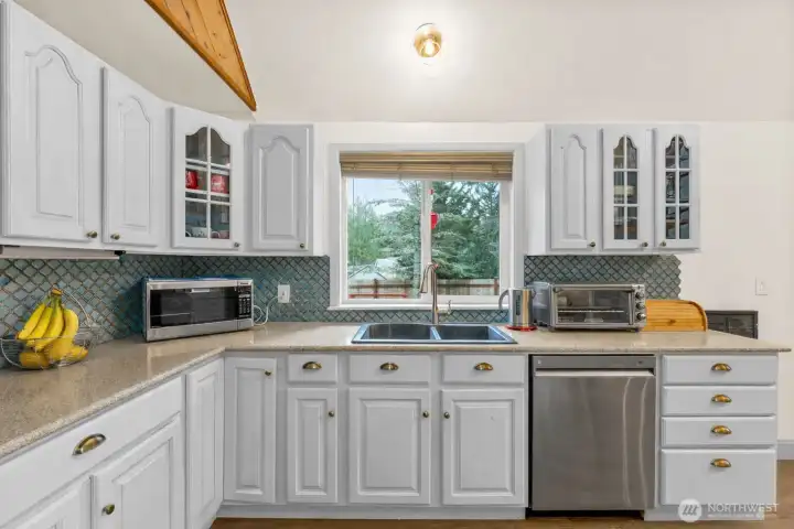 Enjoy the view at the kitchen sink. Updated kitchen with stainless appliances.