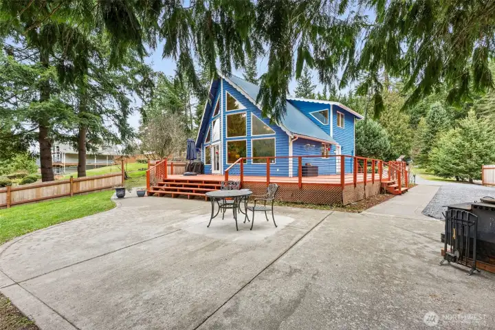 Alder Lake House is designed for gathering, retreating, and taking in the view from multiple locations including this large patio off the wraparound deck.