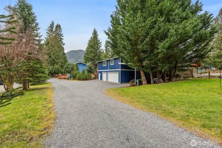 Gravel driveway leads you down to the garage/shop/DADU and main house.