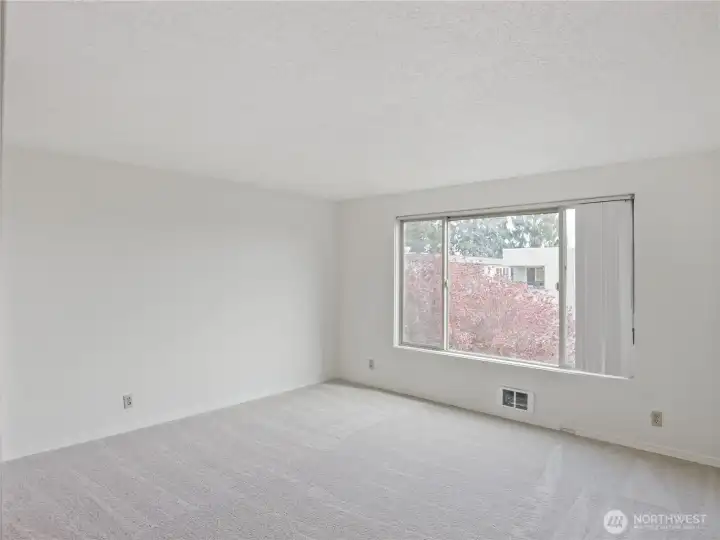 Spacious primary bedroom. Located at the back side of building for quiet nights.