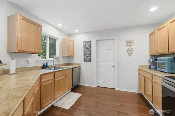 Spacious kitchen with newer appliances and granite countertops.