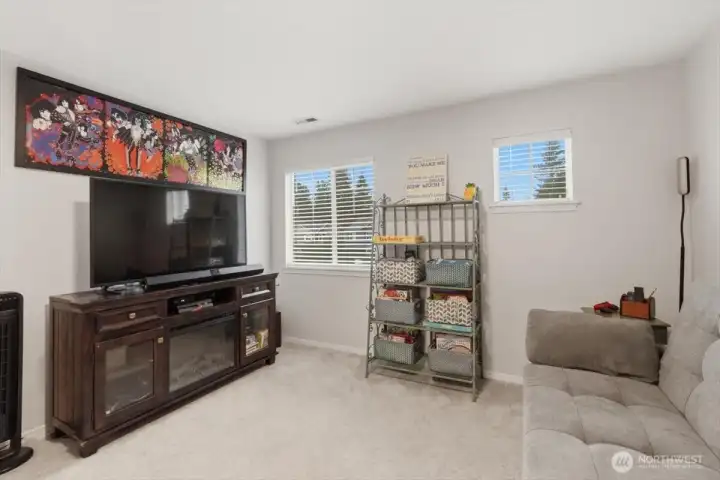 Lofted bonus room at the top of the stairs.