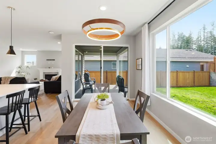 The dining area is constantly bathed in light from the large windows