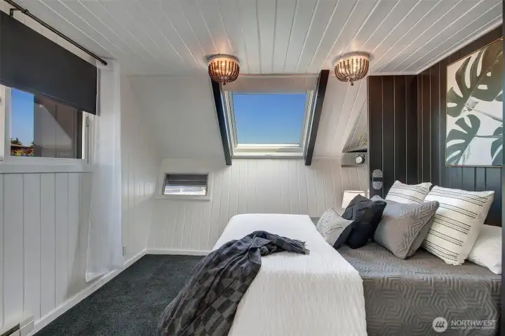 The first bedroom is on the main floor, adjacent from the bathroom.  Enjoy extra storage under the bed and in a built in dresser.